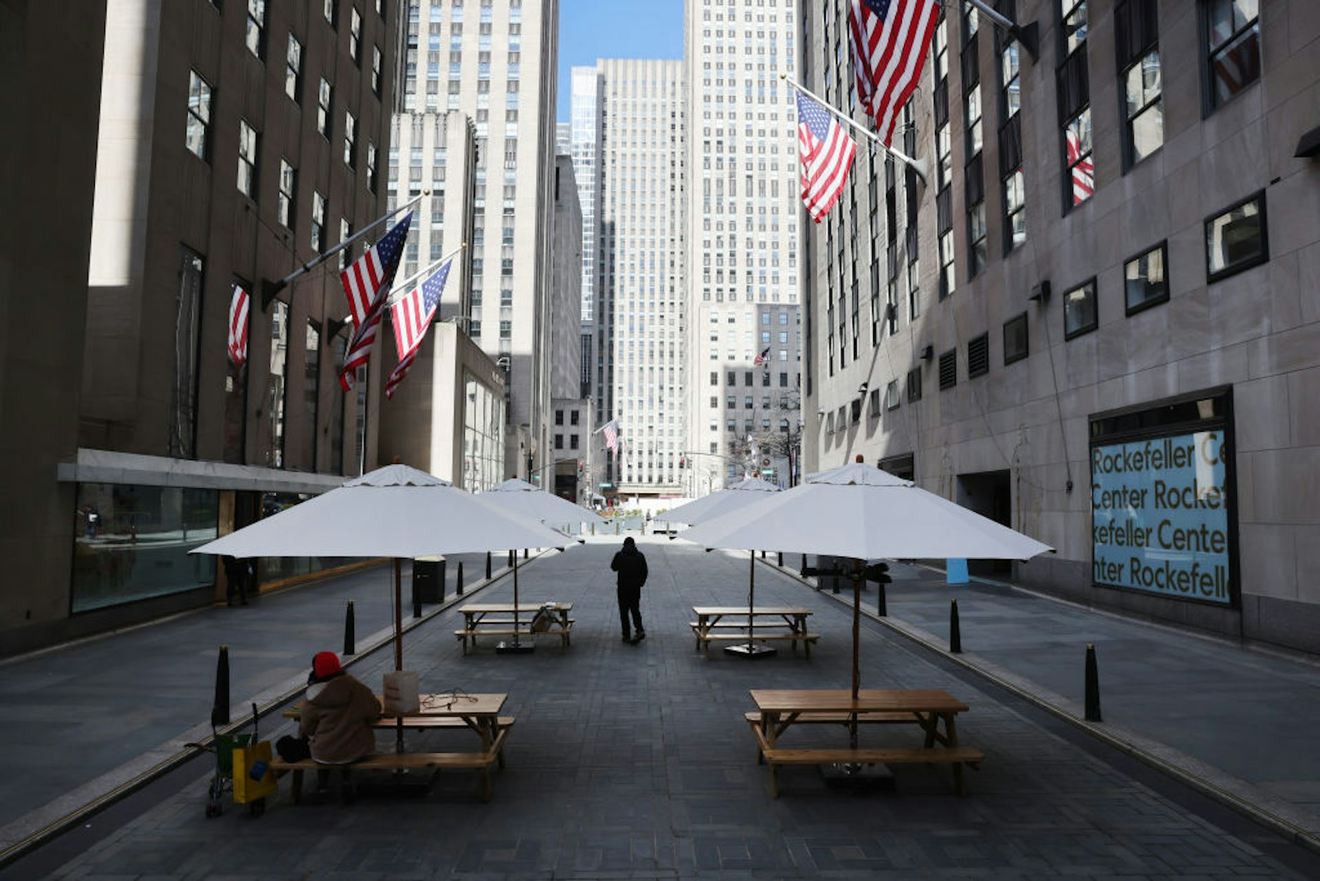A normally busy city street featuring just a couple of pedestrians.