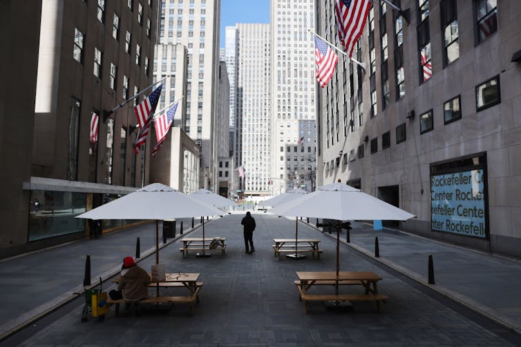A normally busy city street featuring just a couple of pedestrians.