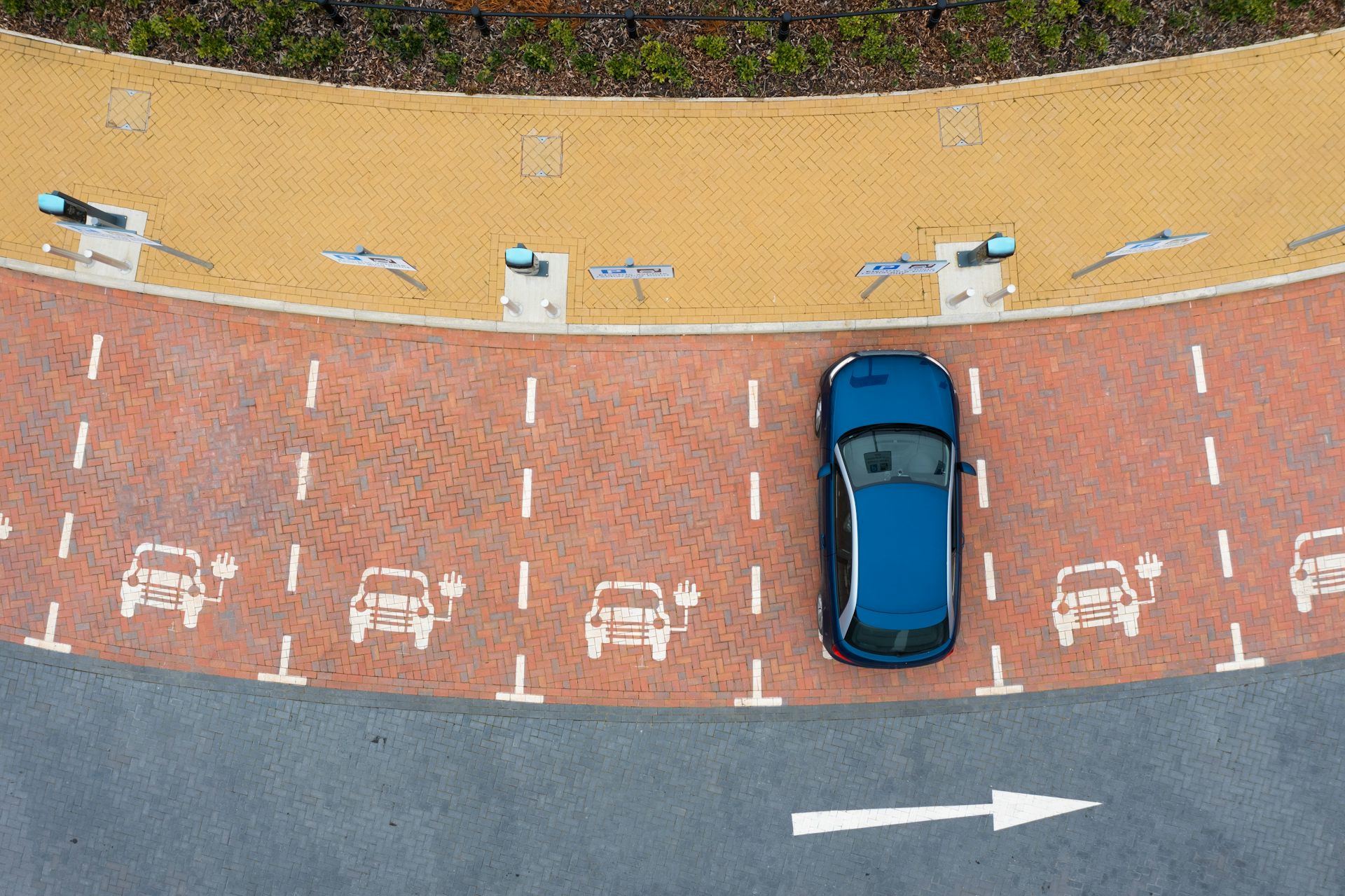 Aerial view of electric vehicle at charging point.