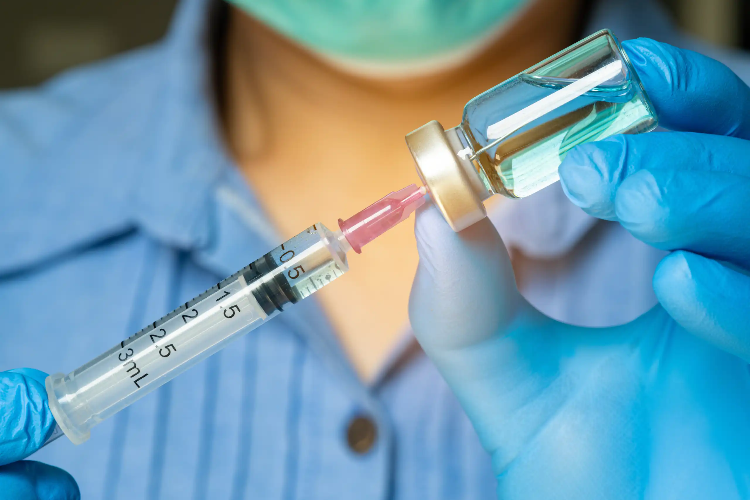 A doctor prepares a vaccine.