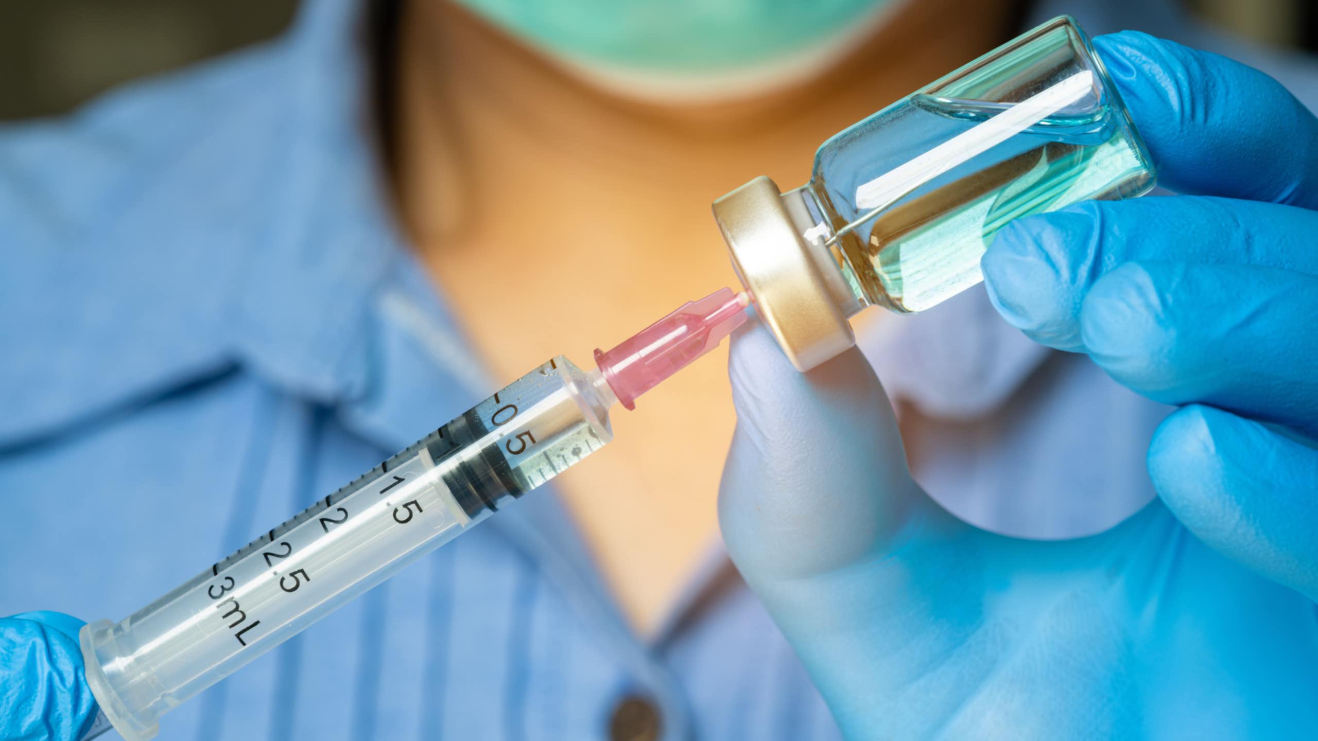 A doctor prepares a vaccine.