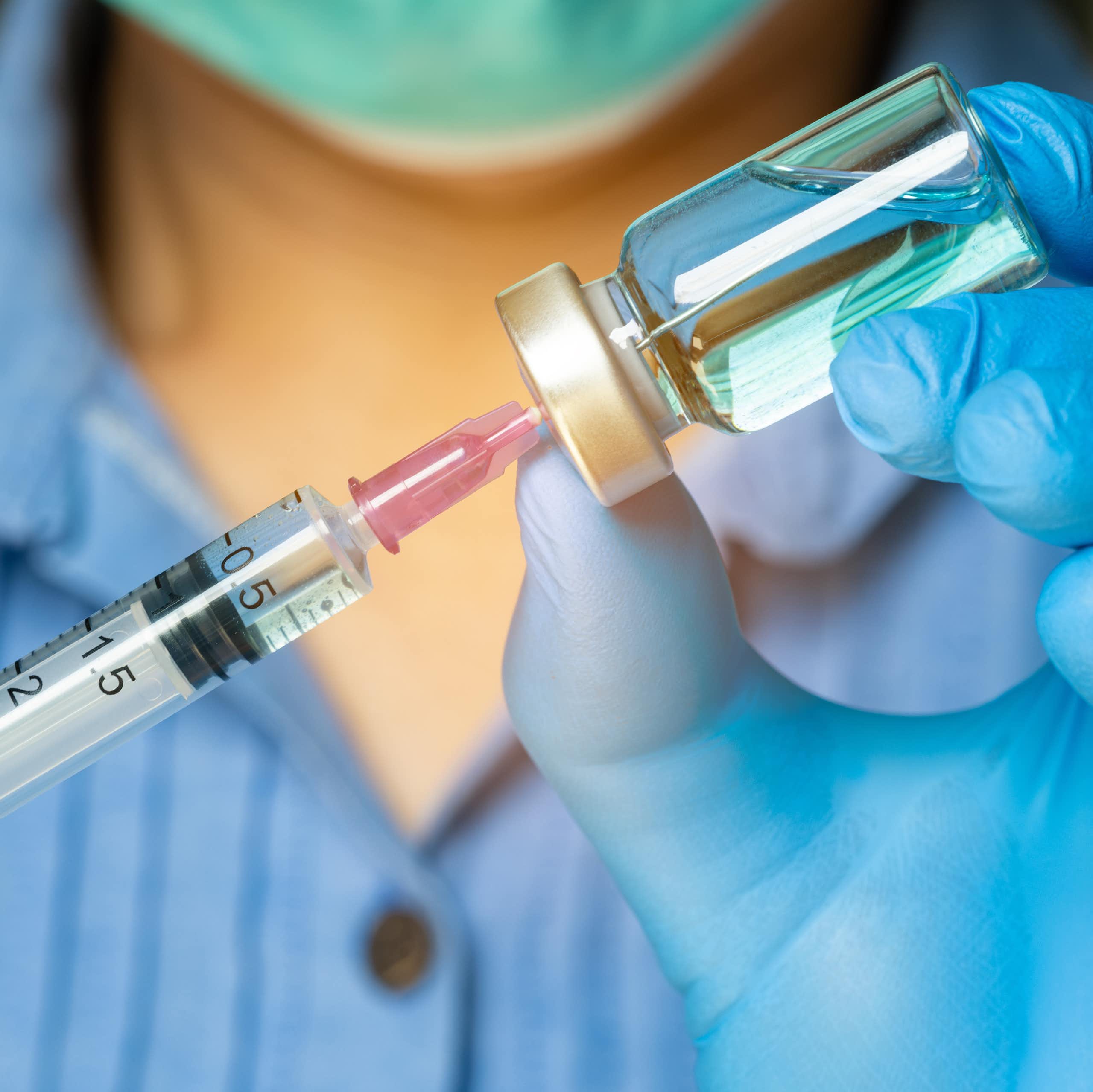 A doctor prepares a vaccine.