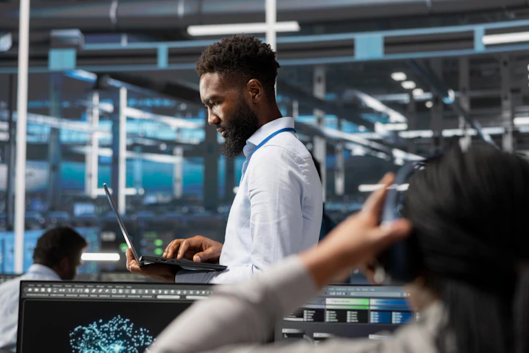 Man looking at computer in an industrial environment