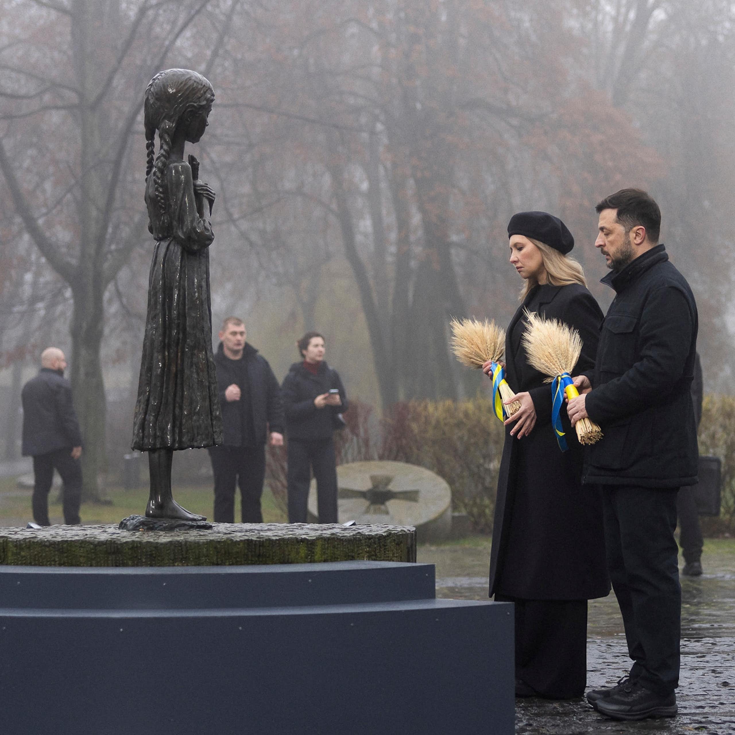 Volodymyr Zelensky and his wife Olena Zelenska place wreaths on a memorial.