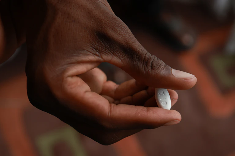 patient holds a medication used for the treatment of HIV infection in adults