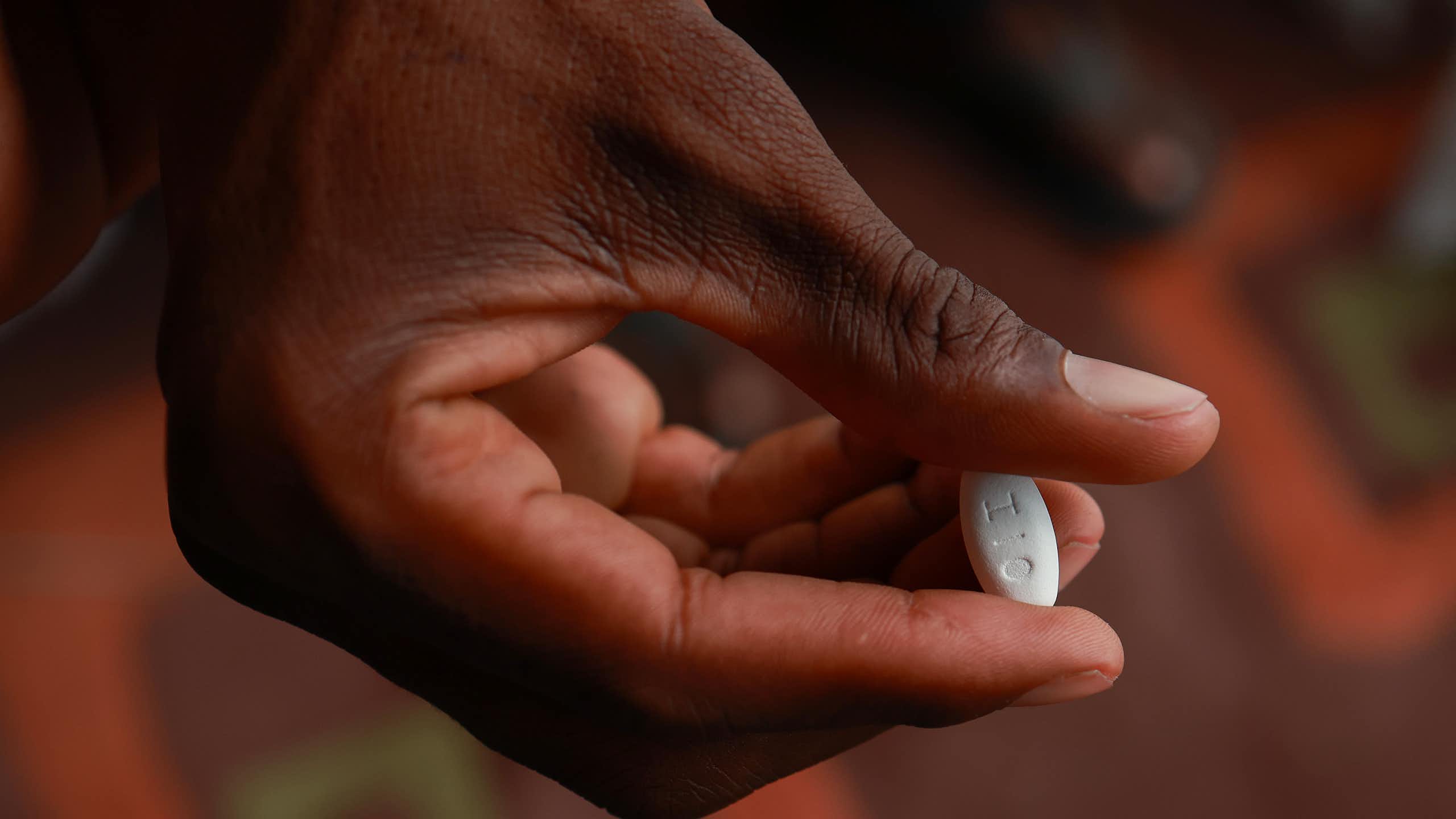 patient holds a medication used for the treatment of HIV infection in adults