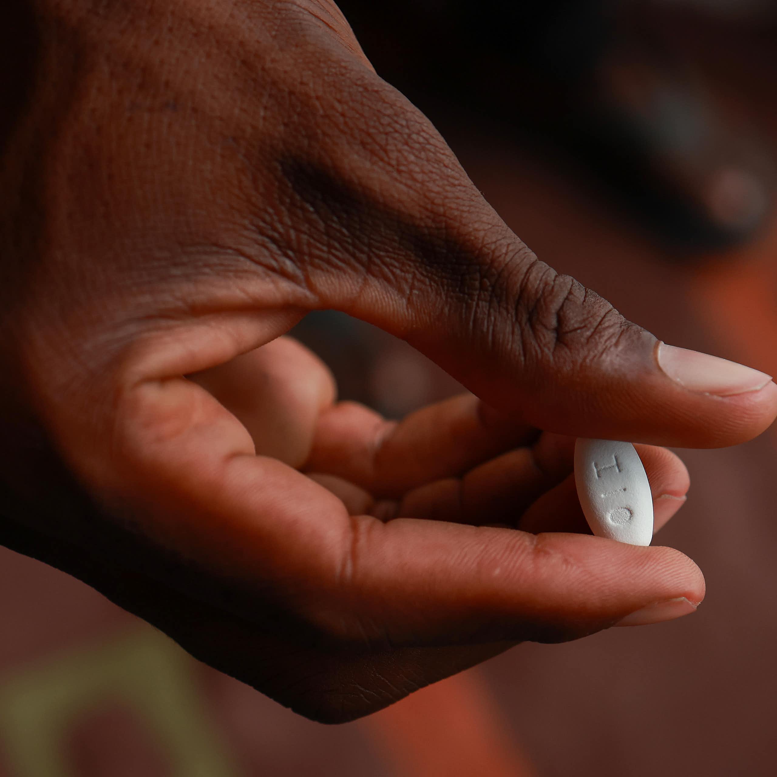 patient holds a medication used for the treatment of HIV infection in adults