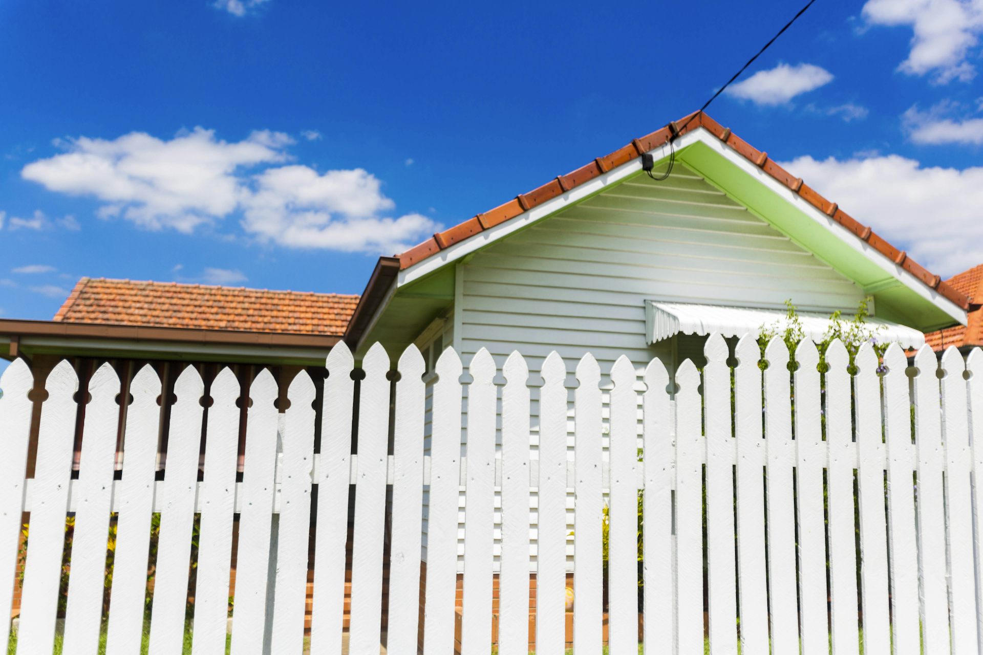 House seen behind a white fence
