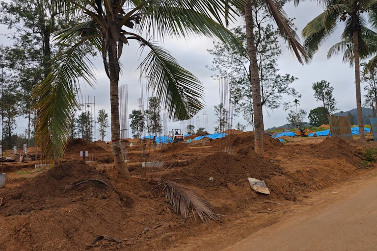 building on land with palm trees in India