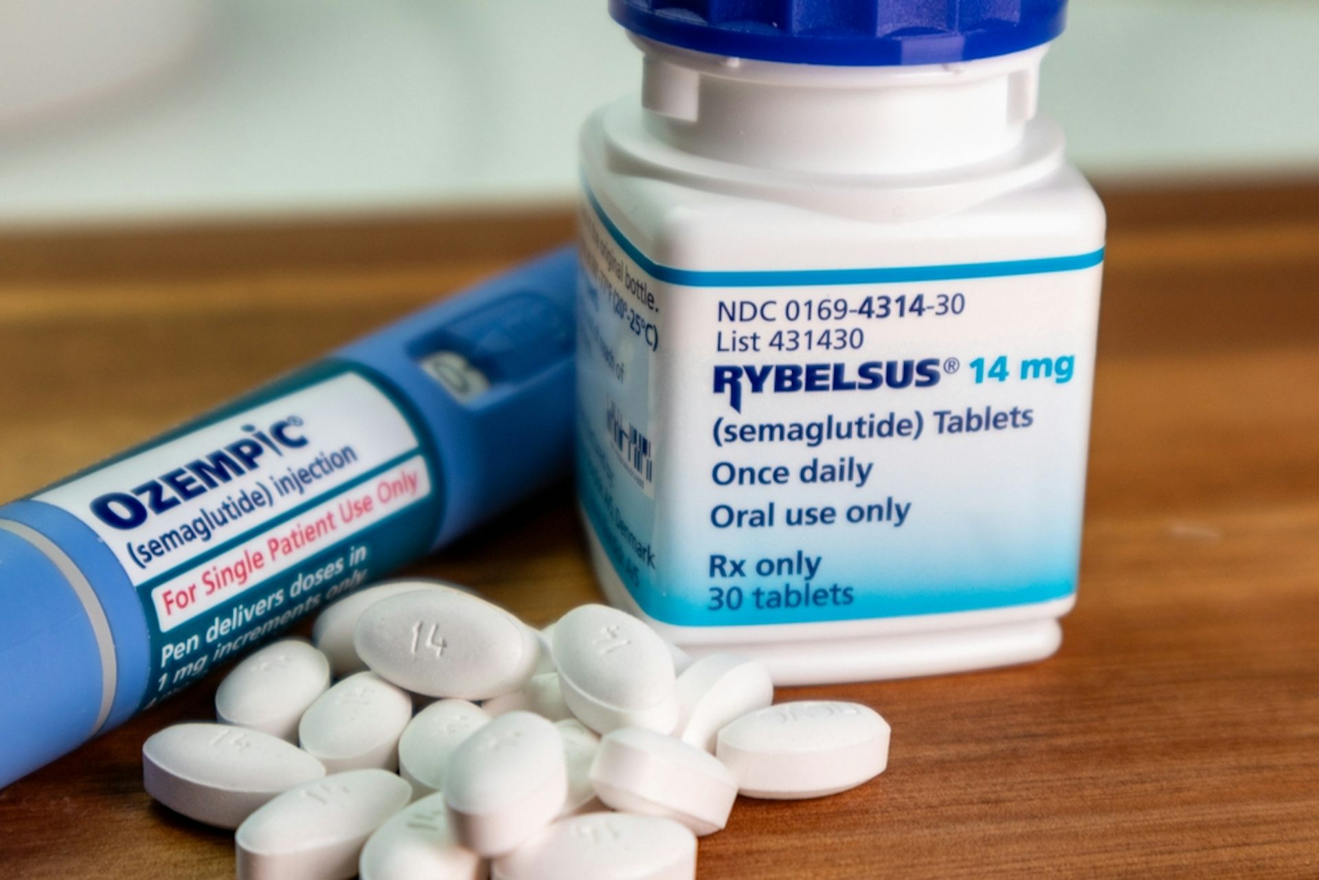 A bottle containing Rybelsus pills, with an Ozempic injector pen on the side.