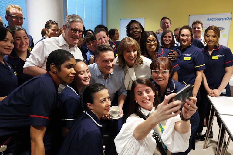 Rachel Reeves and Keir Starmer pose for a selfie with nurses.
