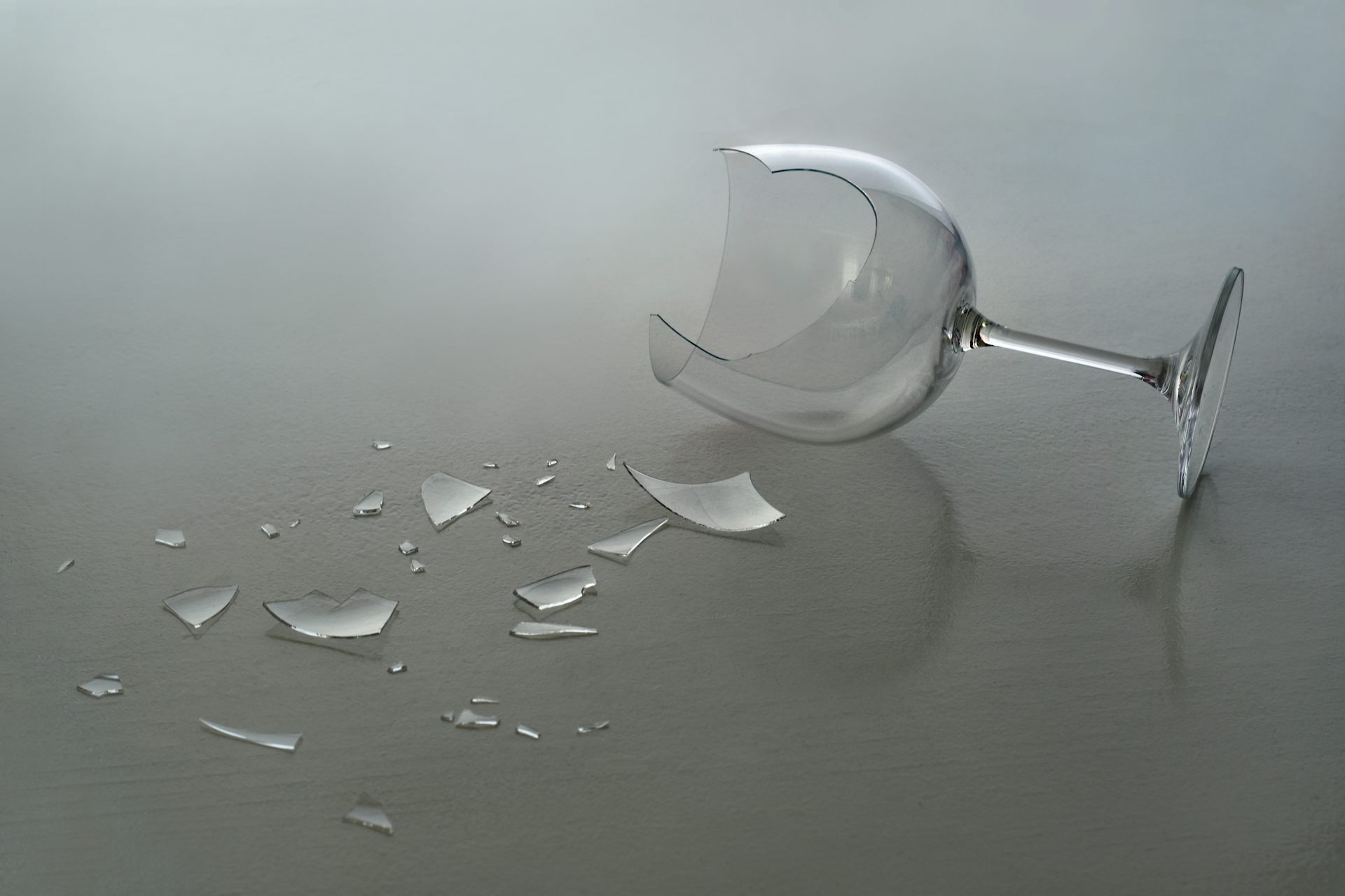 Broken wine glass on the floor.