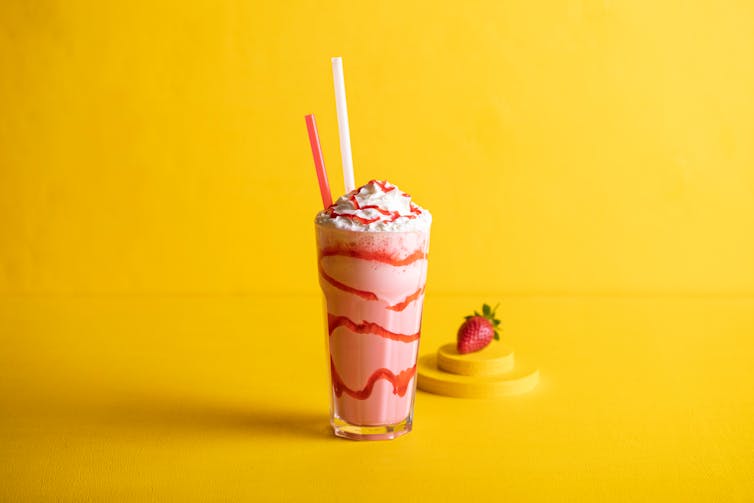 Pink milkshake in a glass.