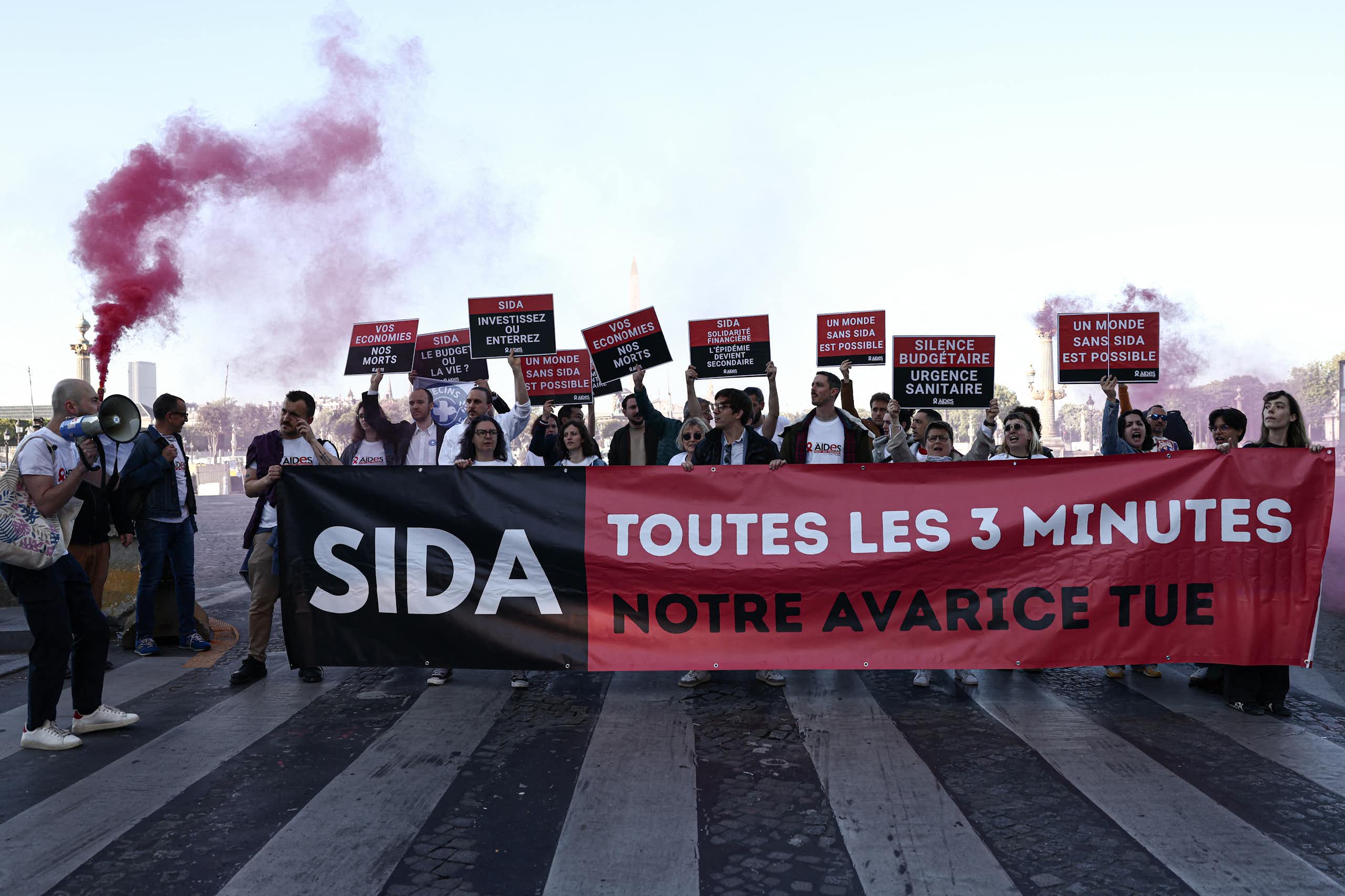 Des personnes manifestent à l’appel de l'association française AIDES, pour protester contre les coupes budgétaires décidées par l’administration américaine en matière notamment de lutte contre le VIH.