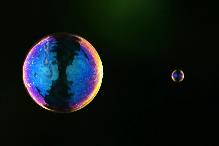 Two soap bubbles, one small one large.