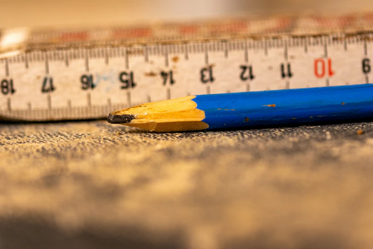 Measuring tape and pencil