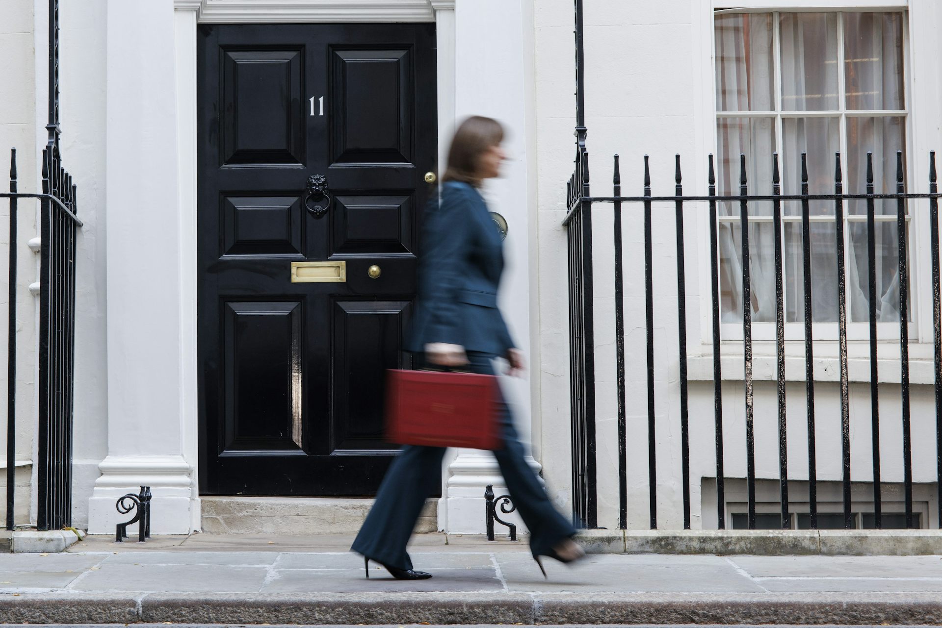 Rachel Reeves walks in a blur past Number 11 holding her red budget box