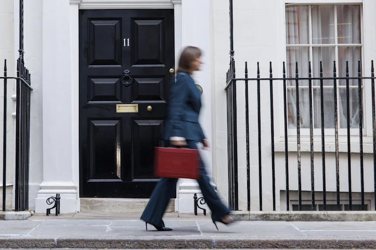 Rachel Reeves walks in a blur past Number 11 holding her red budget box