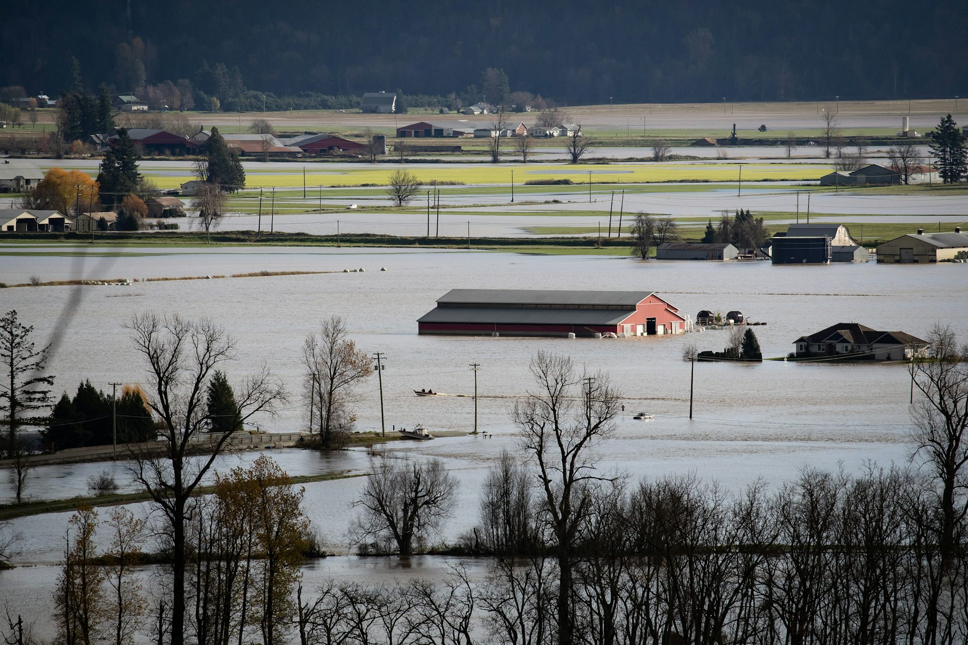 floodwaters around an inundated barn in a farm area