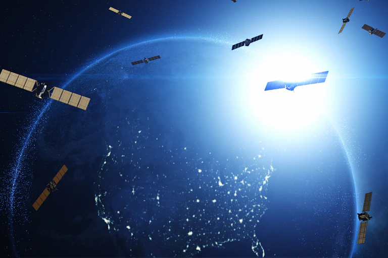 An illustration of satellites scattered throughout orbit, with Earth visible in the background.
