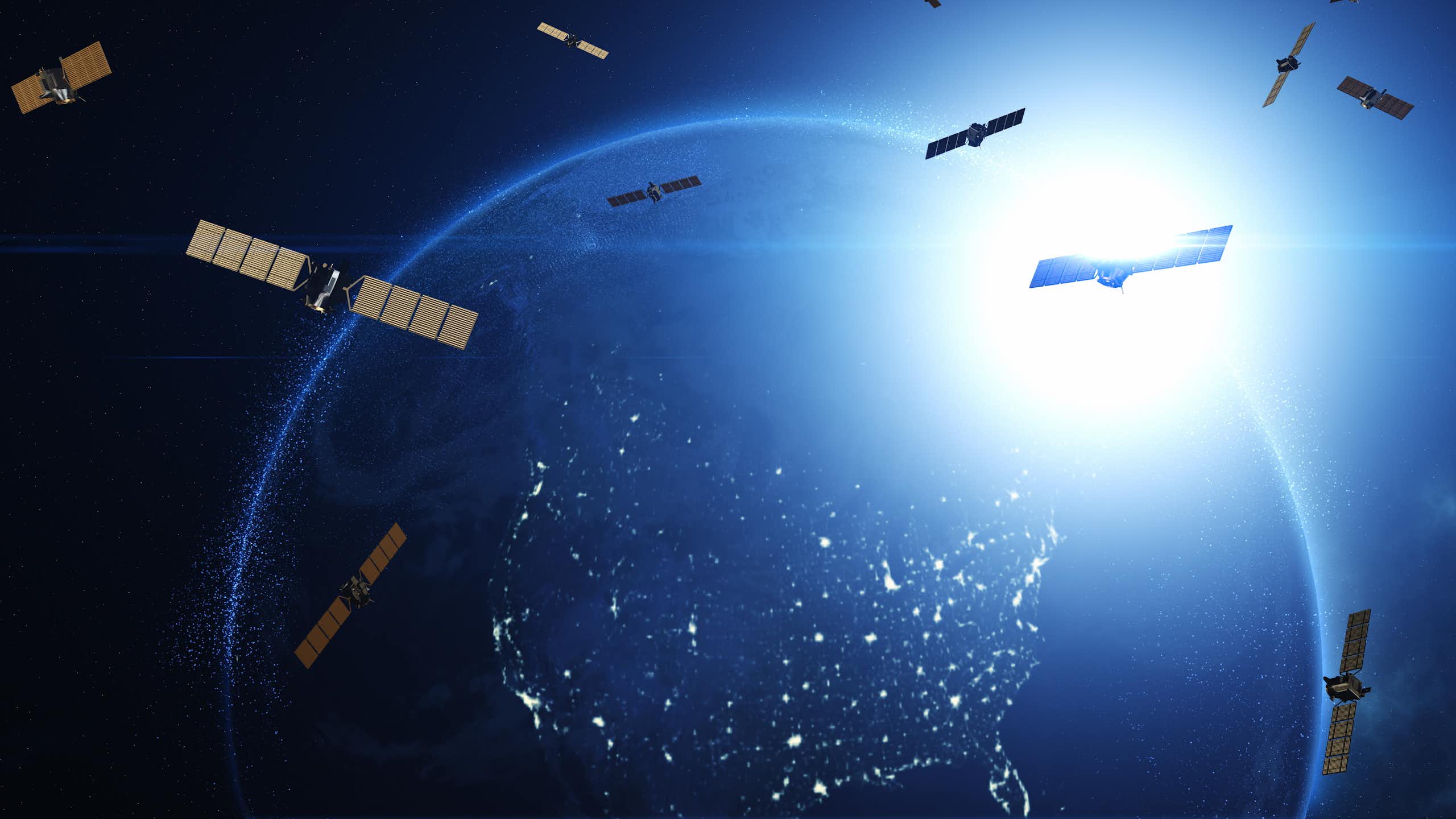 An illustration of satellites scattered throughout orbit, with Earth visible in the background.