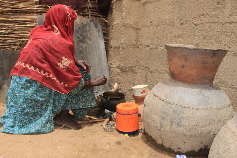 A woman cooking with firewood