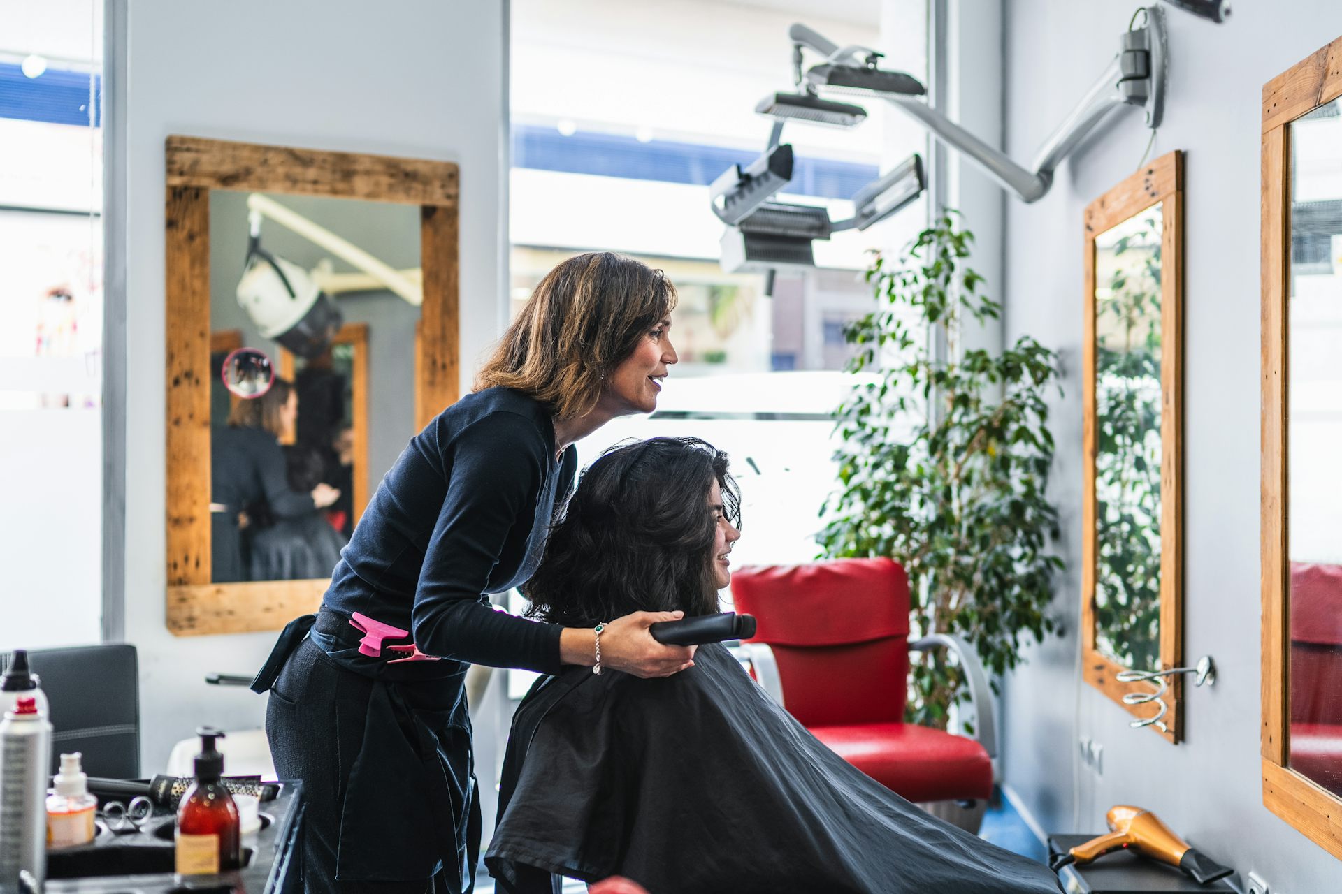 female hairdresser working with a female client in a salon