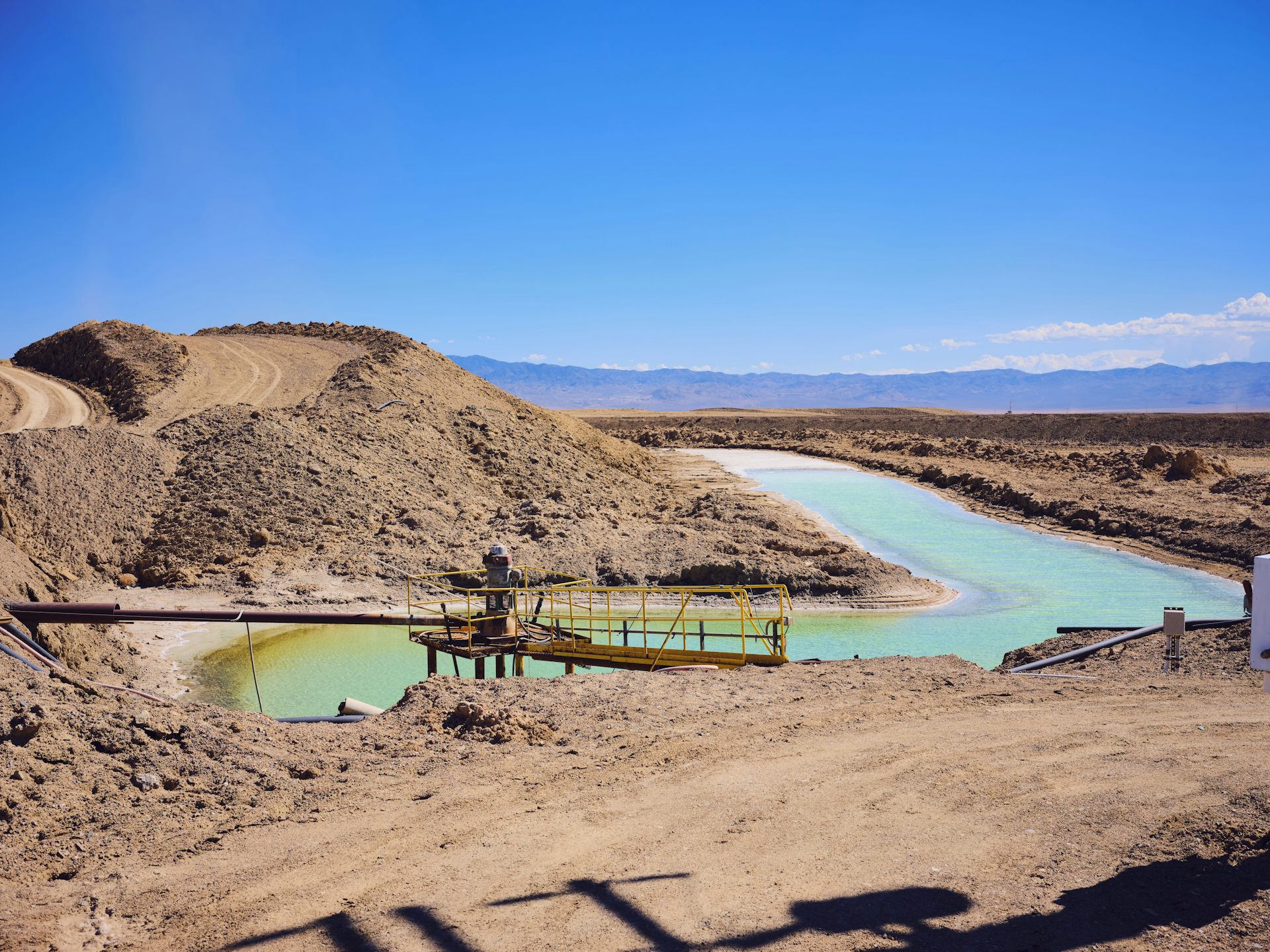 A view of green coloured pools among a desolate landscape.