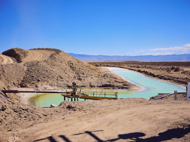 A view of green coloured pools among a desolate landscape.