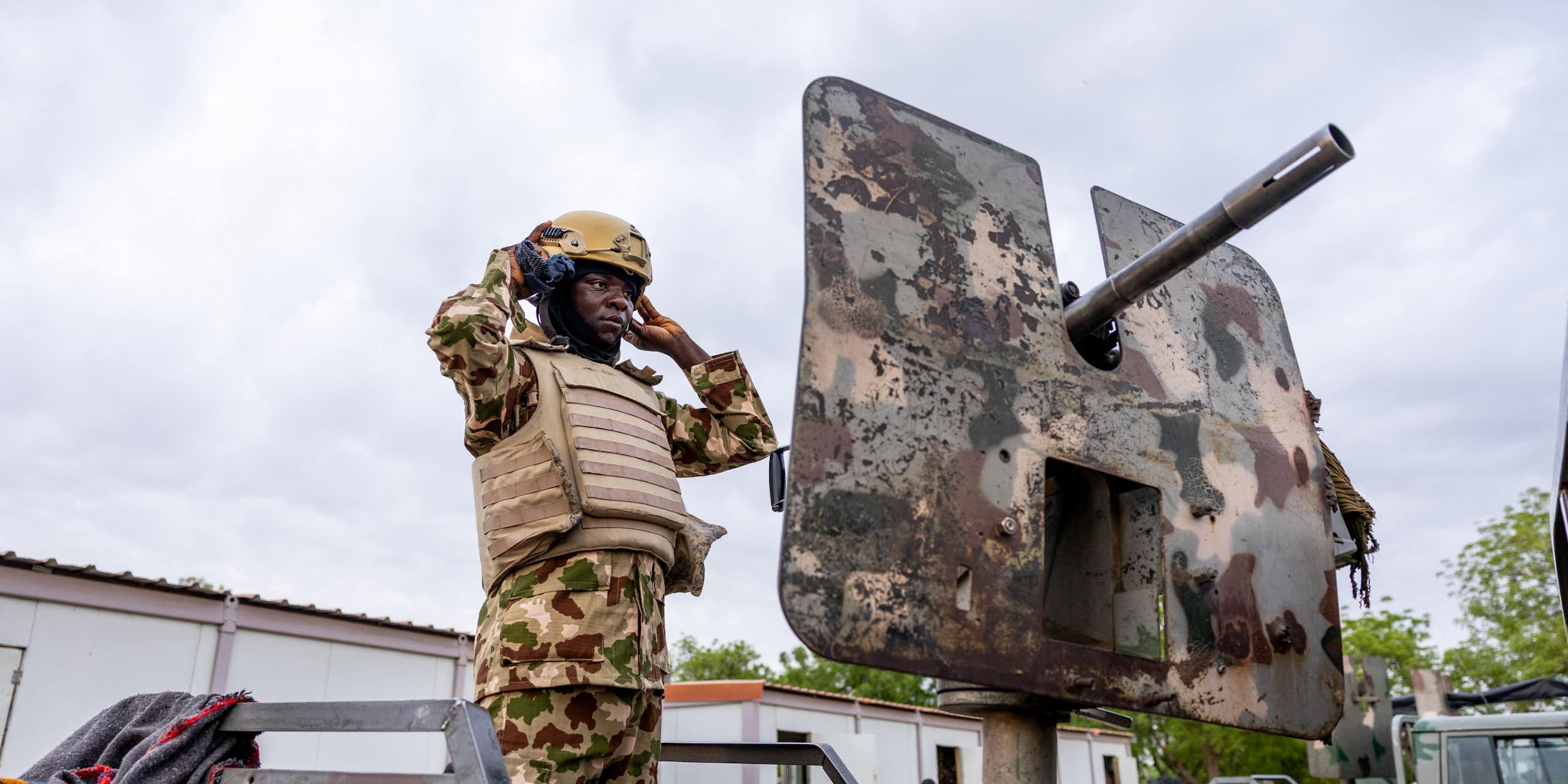 A soldier standing on a gun vehicle