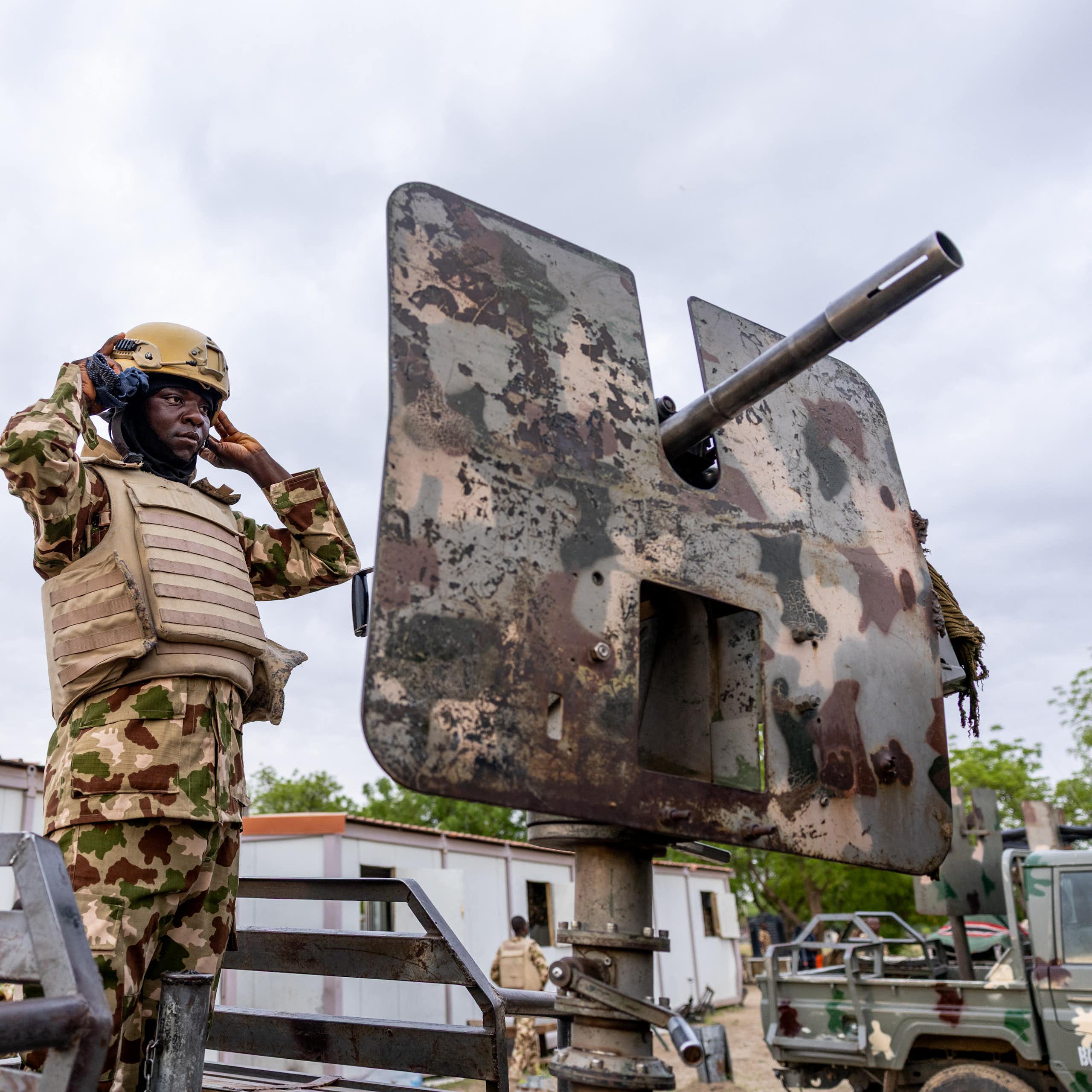 A soldier standing on a gun vehicle