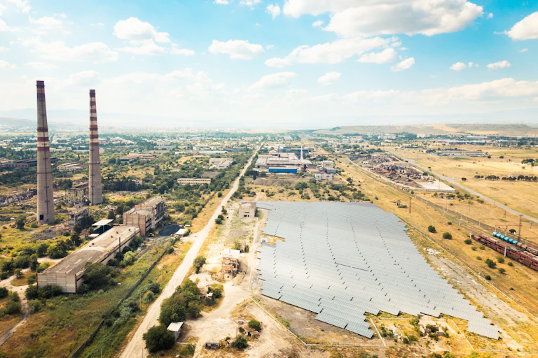 solar farm on brownfield land near industrial factory