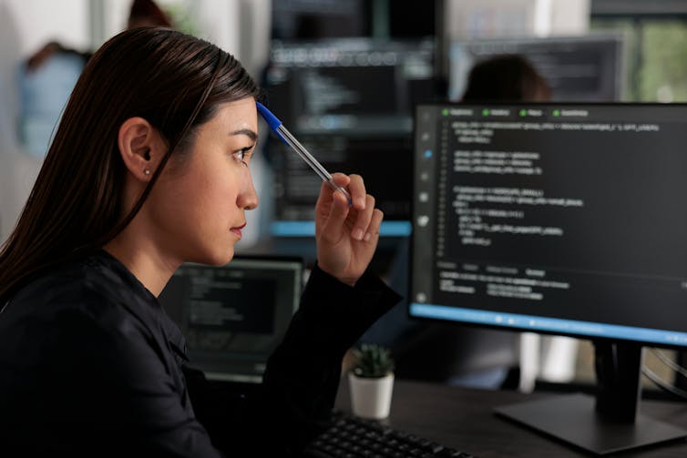 A woman works at a computer