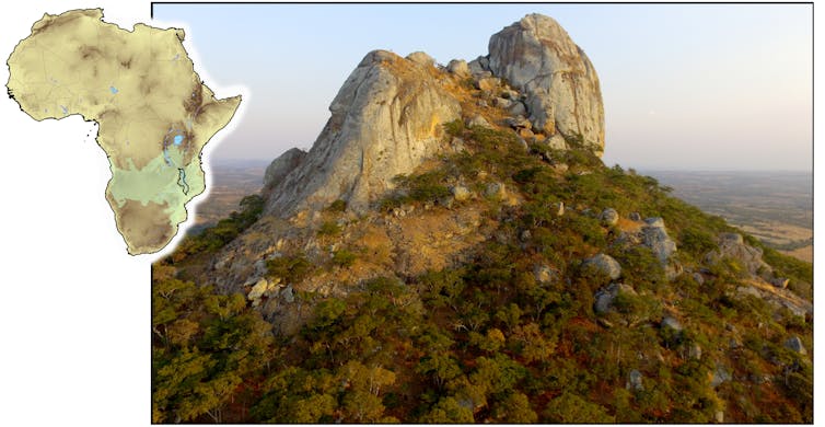 Pequeno mapa da África ao lado de uma grande imagem do topo de uma montanha rochosa ao pôr do sol. As encostas são cobertas por floresta.