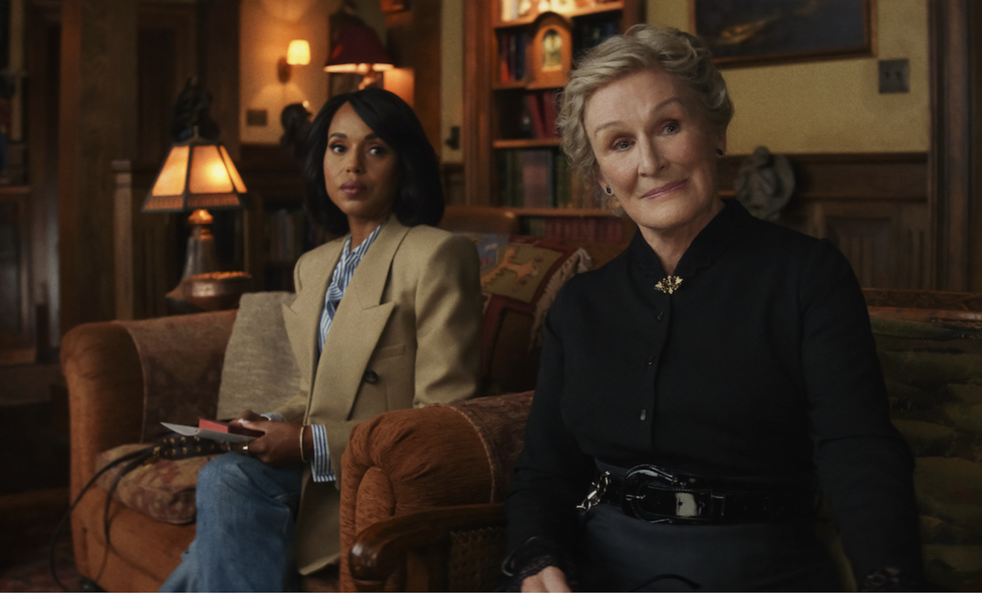 Kerry Washington and Glenn Close sitting together in a dimly lit room.