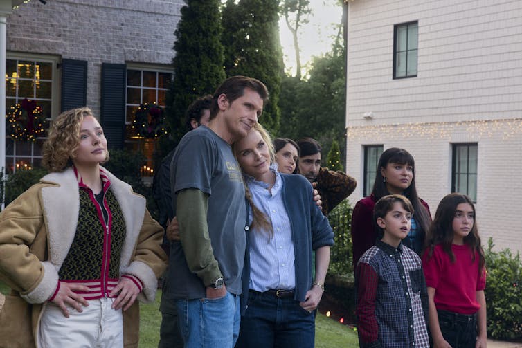 The family gathers on the front lawn.