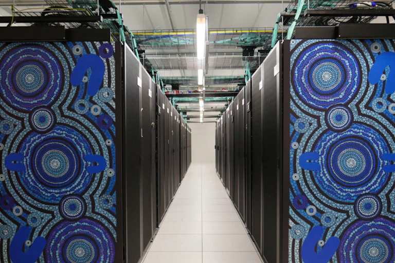 A row of black cabinets with a blue Indigenous artwork on the end.