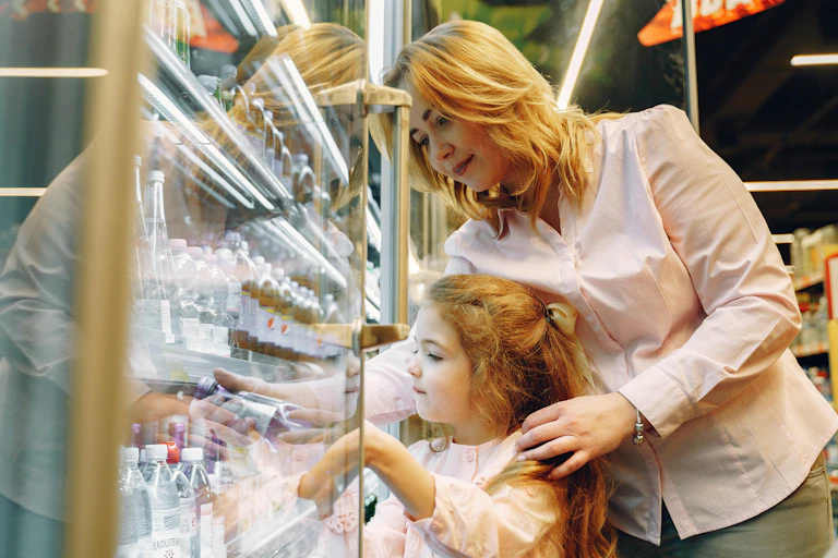 Woman helps daughter choose a drink