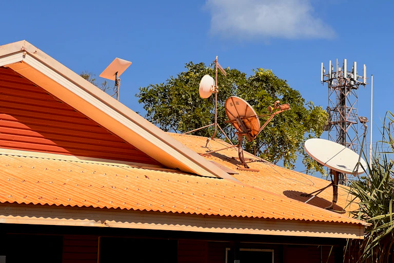 A Starlink dish, on the left, is now part of an array of satellite and mobile services in remote communites in Galiwin'ku NT