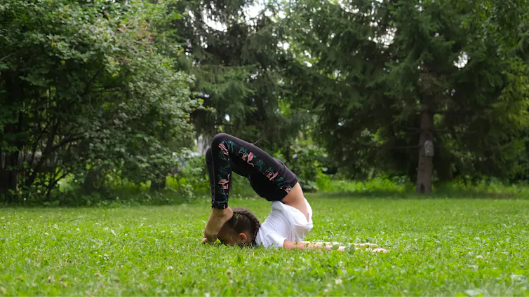 Girl does exercises to strengthen her body and spirit.