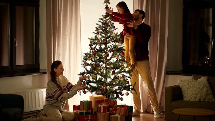 A family decorating a christmas tree