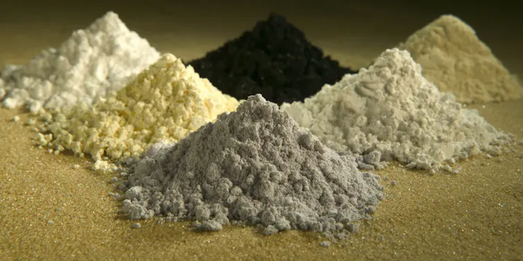 Six small piles of minerals.