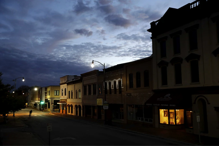 A small-town main street at dusk.