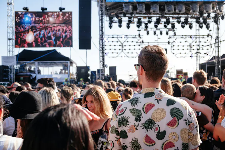 Audience members at an outdoor music festival