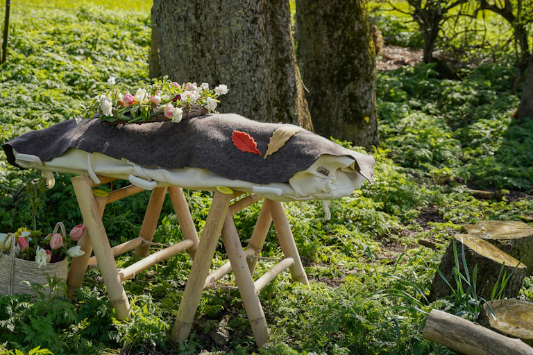 An example of an eco-friendly woodland funeral and natural burial with a woollen shroud instead of a traditional coffin.