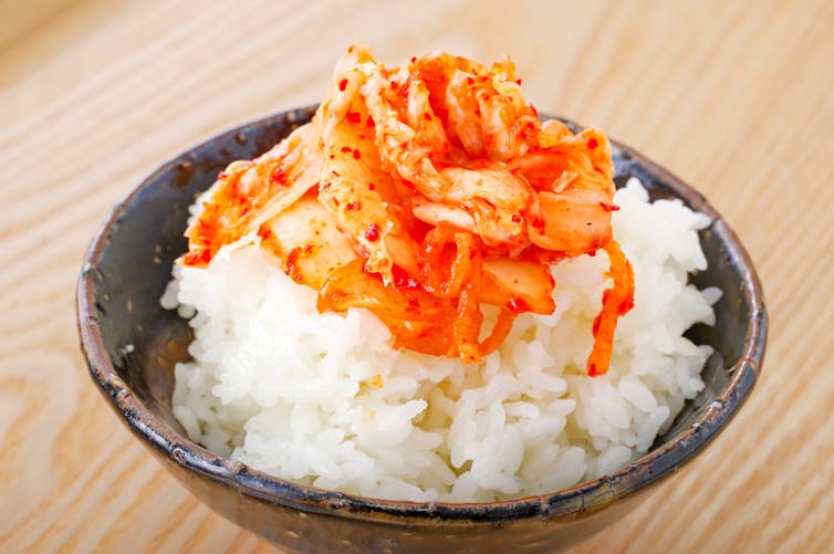 Kimchi piled on top of a bowl of rice.