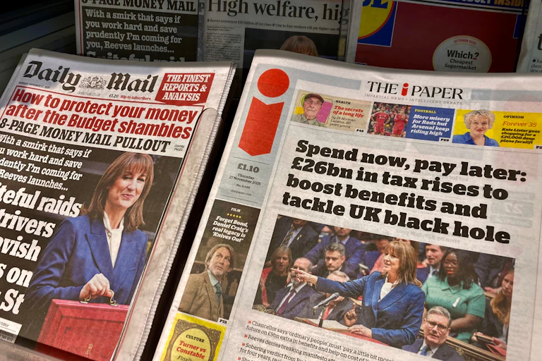 uk newspapers on a newstand the day after the autumn budget.