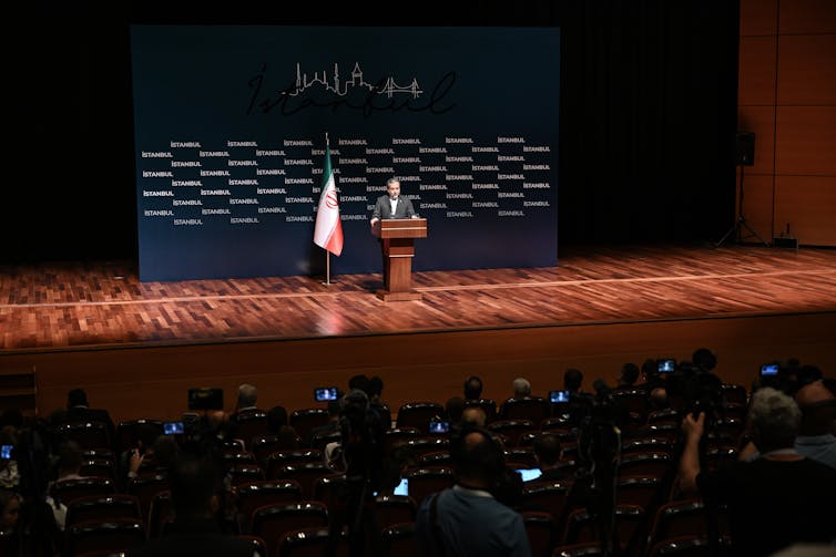 A man gives a speech at a conference.