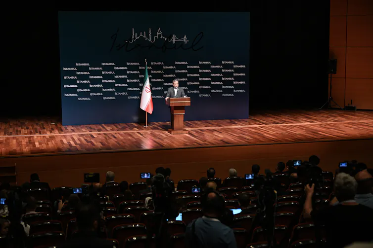 A man gives a speech at a conference.