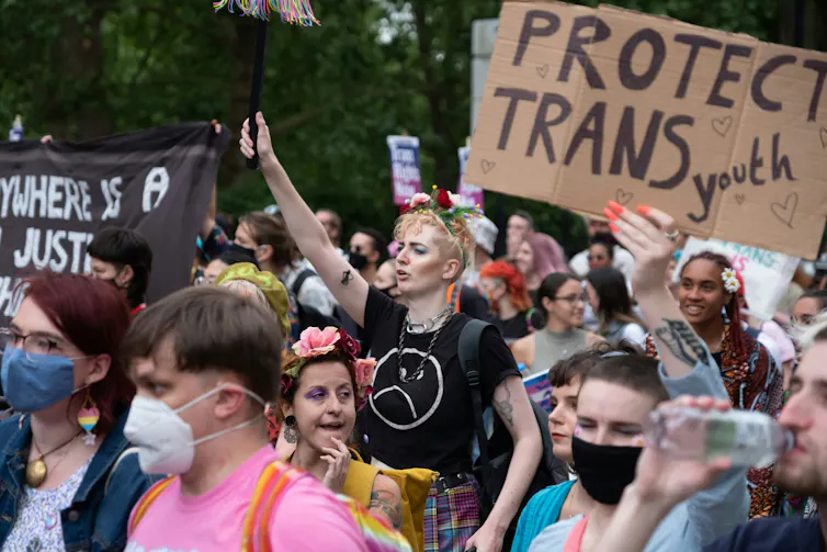 A crowd of protesters on the street walking.
